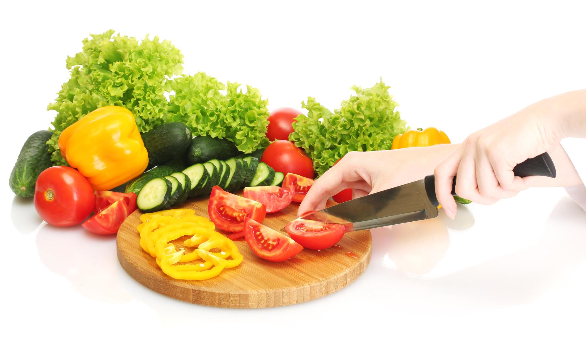 Close-up of hands chopping vegetables with smart scale